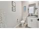 Well-lit half bathroom featuring a granite countertop, framed mirror, and decorative floral accents at 17032 Harvest Moon Way, Bradenton, FL 34211