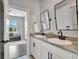 Bathroom with granite countertop vanity and well-lit mirror at 17032 Harvest Moon Way, Bradenton, FL 34211