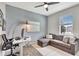 Bright bedroom with an accent wall, ceiling fan, comfortable seating and a work space at 17032 Harvest Moon Way, Bradenton, FL 34211