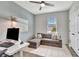 Bright bedroom featuring a gray accent wall, ceiling fan, and stylish furniture; perfect for a cozy retreat at 17032 Harvest Moon Way, Bradenton, FL 34211
