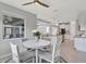 Bright dining area with a white table and views into the kitchen and screened-in patio at 17032 Harvest Moon Way, Bradenton, FL 34211