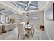 Stylish dining room with a modern light fixture and seating for six under a tray ceiling at 17032 Harvest Moon Way, Bradenton, FL 34211