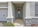 Inviting front entryway with stone accents and a well-lit covered porch at 17032 Harvest Moon Way, Bradenton, FL 34211