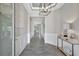 Elegant entryway with tile flooring, decorative wall paneling, and stylish light fixture at 17032 Harvest Moon Way, Bradenton, FL 34211