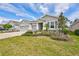 Well-maintained one-story home with three-car garage and beautifully landscaped front yard at 17032 Harvest Moon Way, Bradenton, FL 34211