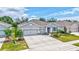 A charming single-Gathering home with a well-manicured lawn, a three-car garage and stone accents at 17032 Harvest Moon Way, Bradenton, FL 34211