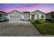 Beautiful one-story home featuring a three-car garage and a well-manicured lawn at 17032 Harvest Moon Way, Bradenton, FL 34211