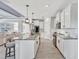 Open kitchen with stainless steel appliances, granite counters, a large island, and a view to the living room at 17032 Harvest Moon Way, Bradenton, FL 34211