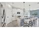 Well-lit kitchen featuring a large island with seating and a view of the dining area at 17032 Harvest Moon Way, Bradenton, FL 34211