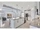 Open-concept kitchen with a large center island, stainless steel appliances, and a view to the living area at 17032 Harvest Moon Way, Bradenton, FL 34211