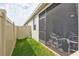 Side view of screened lanai with seating and a private, fenced yard area at 17032 Harvest Moon Way, Bradenton, FL 34211