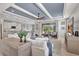 Open-concept living area with comfortable furnishings and views of the backyard and kitchen at 17032 Harvest Moon Way, Bradenton, FL 34211