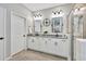 Bright main bathroom with double sinks, granite countertops, and a glass enclosed shower at 17032 Harvest Moon Way, Bradenton, FL 34211