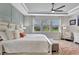 Large main bedroom with tray ceilings, plush decor, and many windows for ample light at 17032 Harvest Moon Way, Bradenton, FL 34211