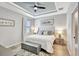 Serene bedroom featuring a ceiling fan, soft lighting, and a plush bed with decorative pillows at 17032 Harvest Moon Way, Bradenton, FL 34211