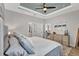 Cozy main bedroom with a ceiling fan, dresser, and well-appointed decor, creating a relaxing atmosphere at 17032 Harvest Moon Way, Bradenton, FL 34211