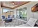 Covered outdoor patio featuring stylish furniture, ceiling fan, and view into the home interior at 17032 Harvest Moon Way, Bradenton, FL 34211