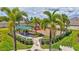 Community playground featuring a covered picnic area, swings, slides, and lush landscaping at 17032 Harvest Moon Way, Bradenton, FL 34211