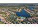 Aerial view showcasing the community's lakefront homes, tennis courts, and pool area at 1831 Burgos Dr, Sarasota, FL 34238