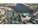 Community aerial view featuring tennis courts, clubhouse pool, and waterfront residences at 1831 Burgos Dr, Sarasota, FL 34238