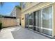 An outdoor back patio with light colored pavers and large sliding doors that enhance the indoor-outdoor flow at 1831 Burgos Dr, Sarasota, FL 34238
