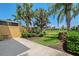 Outdoor patio area surrounded by lush landscaping and privacy wall at 1831 Burgos Dr, Sarasota, FL 34238