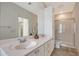 Bright bathroom featuring double vanity, spacious shower, and white cabinets at 1831 Burgos Dr, Sarasota, FL 34238
