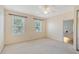 Bright bedroom with 2 windows, ceiling fan, closet, and attached bathroom at 1831 Burgos Dr, Sarasota, FL 34238