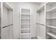 Walk-in closet features shelving and rods for organization at 1831 Burgos Dr, Sarasota, FL 34238