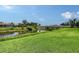 Scenic view of community pond with a bridge, lush greenery, and beautiful landscaping at 1831 Burgos Dr, Sarasota, FL 34238