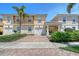 Charming townhome featuring a private garage, covered parking, balcony, and lush landscaping at 1831 Burgos Dr, Sarasota, FL 34238