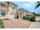 Townhomes with brick paver driveways and well-maintained landscaping at 1831 Burgos Dr, Sarasota, FL 34238