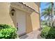 Charming front entrance with a classic white door, ambient lighting, and lush landscaping at 1831 Burgos Dr, Sarasota, FL 34238