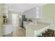 Bright kitchen featuring white cabinets, modern stainless steel appliances, and eat-in breakfast bar at 1831 Burgos Dr, Sarasota, FL 34238