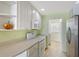 Close up of the kitchen with ample counter space, overhead cabinets, and stainless steel appliances at 1831 Burgos Dr, Sarasota, FL 34238