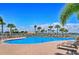 Resort-style community pool with lounge chairs and tropical landscaping at 1831 Burgos Dr, Sarasota, FL 34238