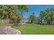 Beautiful backyard features lush tropical landscaping, privacy fence and brick patio at 1857 Jasmine Dr, Sarasota, FL 34239