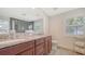 Modern bathroom features a double vanity with granite countertop and tiled shower at 1857 Jasmine Dr, Sarasota, FL 34239