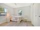 Serene bedroom with natural light, wood-look floors, and a quaint seating area at 1857 Jasmine Dr, Sarasota, FL 34239