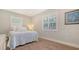 This quaint bedroom has shuttered windows with a queen sized bed and wood flooring for a clean and modern look at 1857 Jasmine Dr, Sarasota, FL 34239