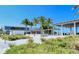 Well-maintained exterior featuring palm trees, modern architecture, and vibrant landscaping at 1857 Jasmine Dr, Sarasota, FL 34239