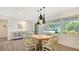 Elegant dining area featuring stylish lighting and modern decor with a view to the outdoors at 1857 Jasmine Dr, Sarasota, FL 34239