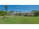 Attractive single-story home with well-manicured lawn and colorful landscaping enhancing curb appeal at 1857 Jasmine Dr, Sarasota, FL 34239