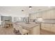 Open kitchen featuring a large island with seating, white cabinetry, and stainless-steel appliances at 1857 Jasmine Dr, Sarasota, FL 34239