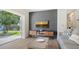 Relaxing living room featuring a stylish accent wall and outdoor access to the backyard at 1857 Jasmine Dr, Sarasota, FL 34239
