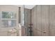 Modern shower with glass door and gray wood-look tile at 1857 Jasmine Dr, Sarasota, FL 34239