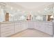 Bathroom with double vanity, white cabinets, and a large mirror at 2136 Bendway Dr, Port Charlotte, FL 33948
