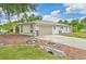 Charming single-story home with attached garage and well-maintained landscaping at 2136 Bendway Dr, Port Charlotte, FL 33948