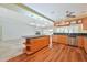 Modern kitchen with wood cabinets, granite countertops, and an island cooktop, perfect for entertaining at 2136 Bendway Dr, Port Charlotte, FL 33948