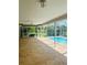 Large screened lanai with decorative concrete, offering views of the pool and backyard at 2136 Bendway Dr, Port Charlotte, FL 33948